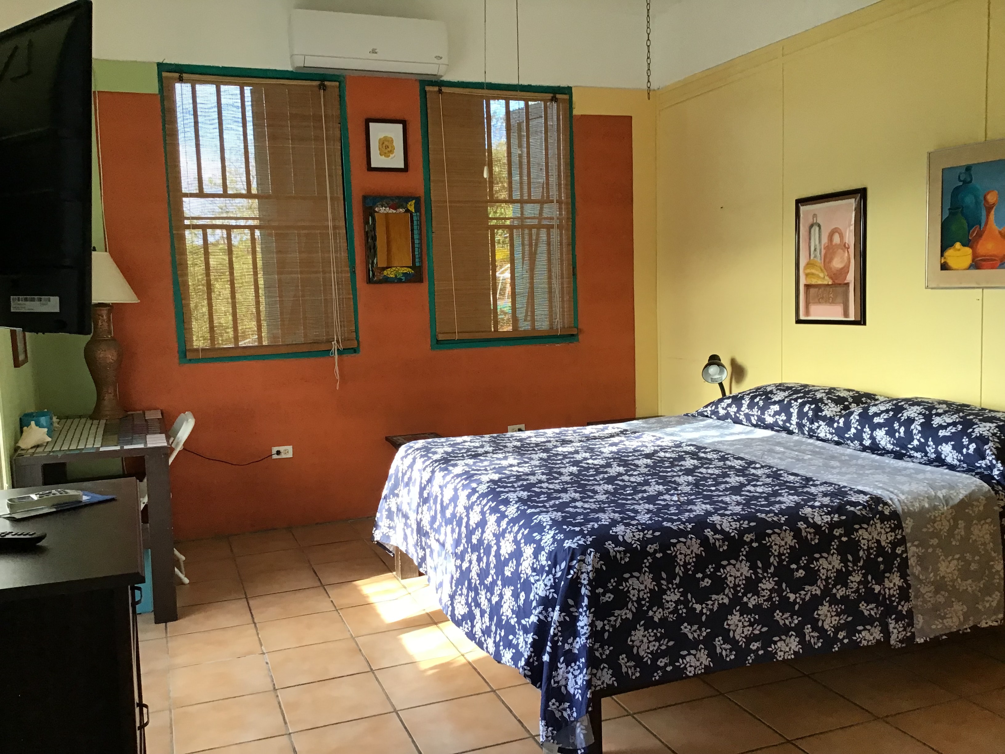 Gaviota bedroom with orange walls and queen bed