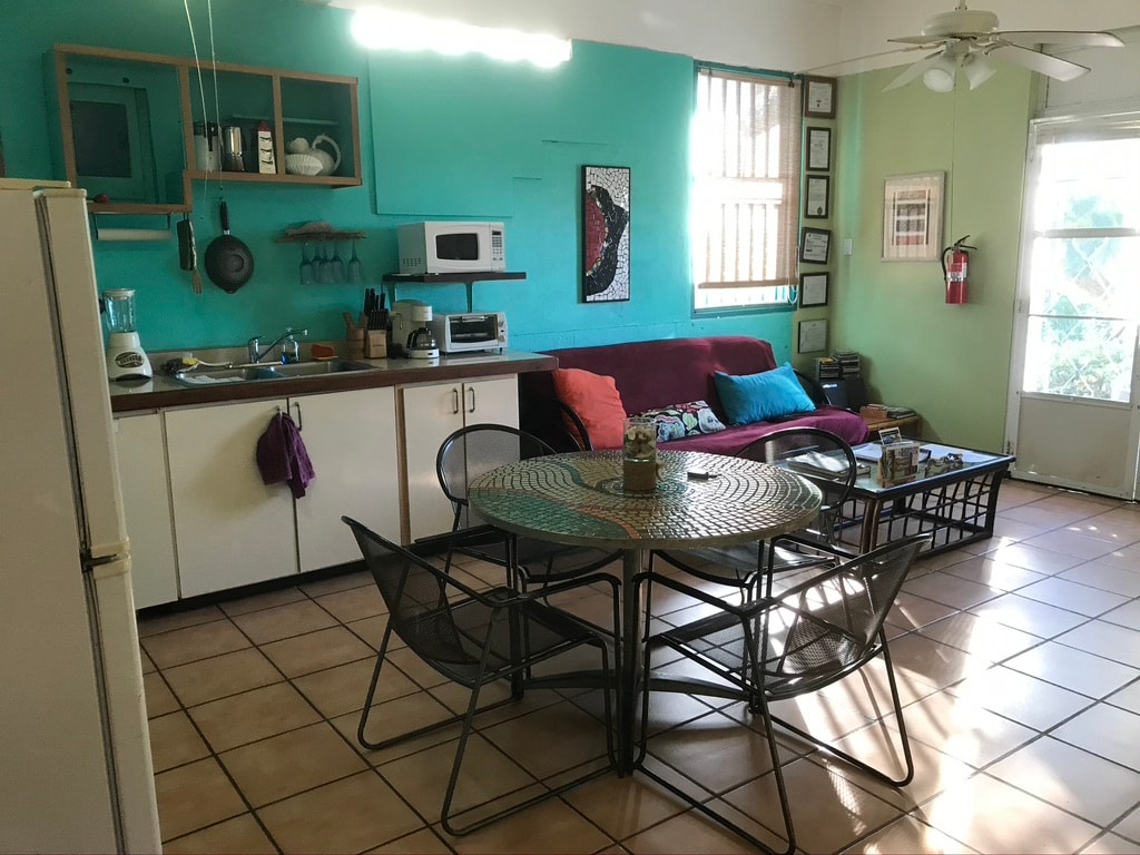 Gaviota kitchen and living area with teal walls and mosaic table
