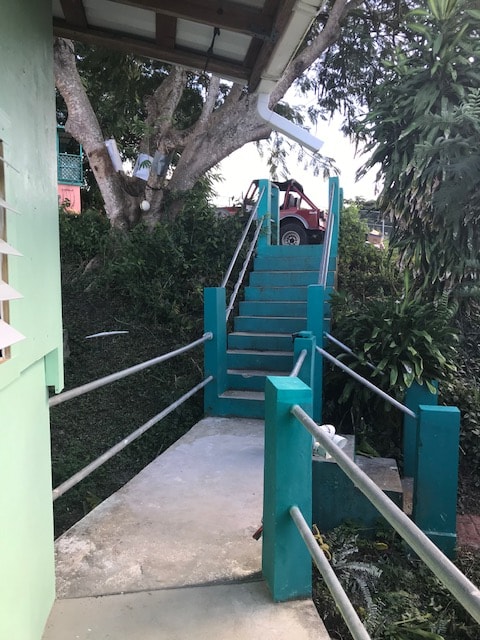 La Paloma teal staircase through tropical grounds